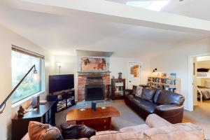 a living room with a couch and a fireplace at Coastal Hideaway in Tillicum Beach