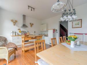 a kitchen and dining room with a table and chairs at Gruppenhaus im Harz in Bad Harzburg