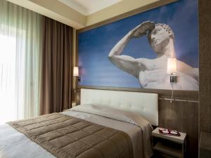 Postel nebo postele na pokoji v ubytování Eracle Hotel