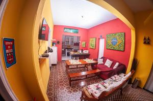 a living room with a couch and a table at Hostel Dragão do Mar Fortaleza in Fortaleza