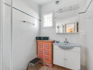 a white bathroom with a sink and a mirror at Sunny Roquebrun Getaway in Roquebrun +33 photos
