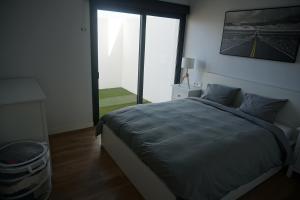 a bedroom with a large bed and a large window at Casa Soleada in La Oliva +16 photos