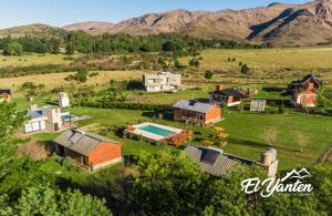 an aerial view of a farm with mountains in the background at Complejo El Yanten in Villa Ventana