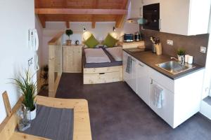 a small kitchen with a couch in a tiny house at Appartment in the Sky in Bílovice nad Svitavou