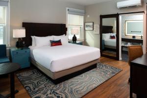 a bedroom with a large white bed and a mirror at Hotel Indigo Spokane Downtown, an IHG Hotel in Spokane