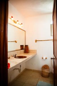 a bathroom with a sink and a mirror at Nacional Beach Club & Bungalows in Mahahual
