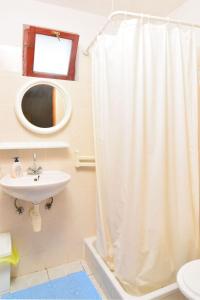 a bathroom with a shower curtain and a sink at House Slavka in Gdinj