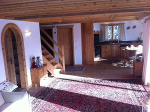 a large room with a kitchen and a dining room at Chesa il Rifugio in St. Moritz