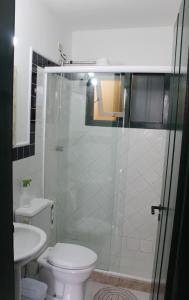 a bathroom with a shower with a toilet and a sink at Casa da Matriz Centro Histórico in Paraty