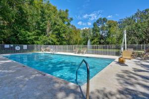 a swimming pool with chairs and a fence at Studio 6 Extended Stay - Jacksonville, FL - Baymeadows in Sunbeam
