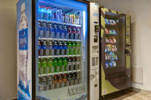 a vending machine filled with lots of bottles of water at Studio 6 Extended Stay - Jacksonville, FL - Baymeadows in Sunbeam +21 photos