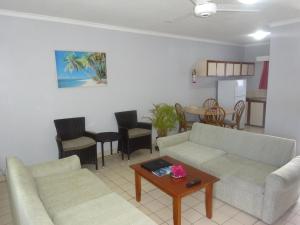 a living room with two couches and a table at Suva Motor Inn in Suva