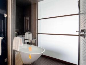 a bathroom with a sink and a bath tub at Fairmont Quasar Istanbul Hotel in Istanbul