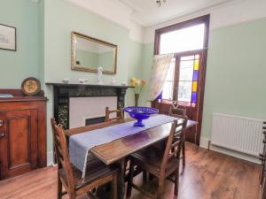 a dining room with a table with a blue bowl on it at Serenity in Ramsgate