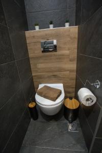 a bathroom with a toilet with a towel on it at Raise Acropolis View Suites in Athens