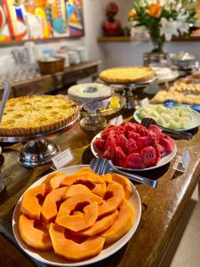 a buffet of pies and other desserts on a table at Pousada João Sol in Praia do Forte