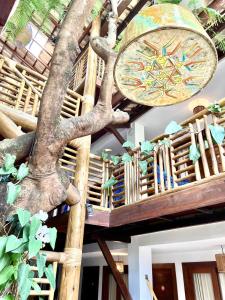 a building with a tree on the ceiling at Pousada João Sol in Praia do Forte
