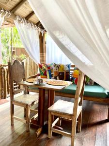 a table and chairs with a table and a couch at Pousada João Sol in Praia do Forte