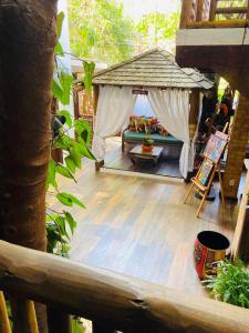 an outdoor patio with a couch and a canopy at Pousada João Sol in Praia do Forte