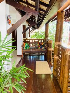 a living room with a bench in a house at Pousada João Sol in Praia do Forte