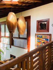 two lights hanging over a staircase with windows at Pousada João Sol in Praia do Forte