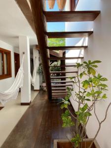 a hallway with a hammock in a house at Pousada João Sol in Praia do Forte