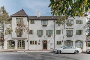 a white car parked in front of a building at L'Auberge Carmel, Relais & Chateaux in Carmel