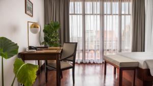 a living room filled with furniture and a window at Amanjaya Pancam Suites Hotel in Phnom Penh