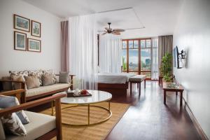a living room with a couch and a table at Amanjaya Pancam Phnom Penh in Phnom Penh