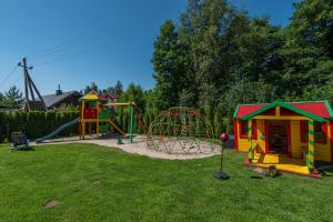 a playground with two play equipment in a yard at OPTIMISTAS in Palanga