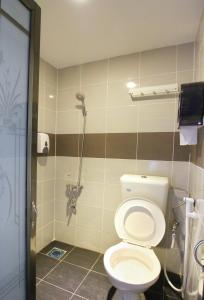 a bathroom with a toilet and a shower at Dream City in Kuching