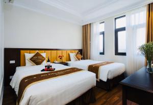 An Phú Hạ Long Luxury Hotel tesisinde bir odada yatak veya yataklar