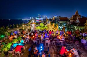 a large group of people sitting at tables in a park at Amanjaya Pancam Suites Hotel in Phnom Penh