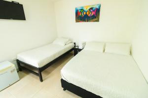Postel nebo postele na pokoji v ubytování Hotel Balcones de Bocagrande