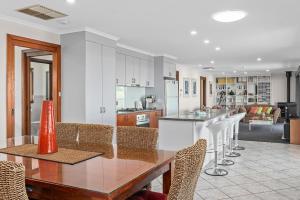 a kitchen and dining room with a table and chairs at Beach House at Moana - C21 SouthCoast Holidays in Moana
