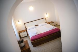 a bedroom with a bed with white sheets and pillows at Villa Andor in Ankaran