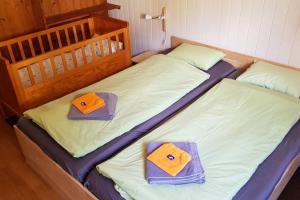 two twin beds with hats and towels on them at Gemütliche Dachwohnung im Chalet mit Bergblick in Engelberg