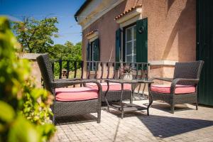a patio with chairs and a table on a balcony at Villa Andor in Ankaran