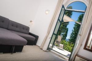 a living room with a couch and a large mirror at Villa Andor in Ankaran