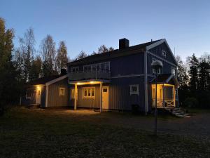 a house with its lights on in front of it at Vandrarhemmet Hörneborg in Örnsköldsvik