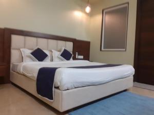 מיטה או מיטות בחדר ב-Taj Sojourn