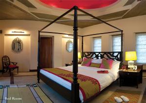 a bedroom with a canopy bed in a room at Tree of Life Resort & Spa Jaipur in Jaipur