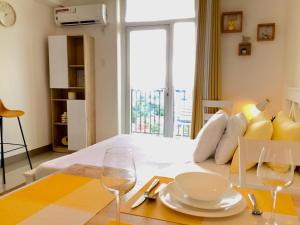 a room with a bed with two glasses and a table at BH Mangrove Condos in Mactan