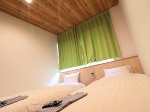 Postel nebo postele na pokoji v ubytování Hiroshima Peace Hotel