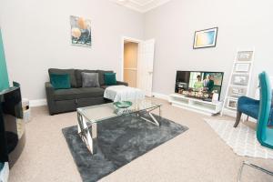 a living room with a couch and a coffee table at The Harrogate Abode in Harrogate +15 photos