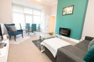 a living room with a couch and a fireplace at The Harrogate Abode in Harrogate