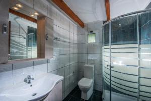 a bathroom with a sink and a toilet at Hotel Aglaia in Kalamaki