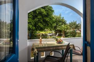 a table and chairs on a balcony with a view at Hotel Aglaia in Kalamaki Heraklion