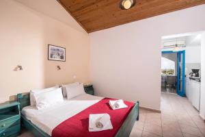 a bedroom with a bed with two white pillows on it at Hotel Aglaia in Kalamaki