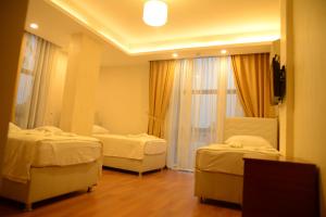 Postel nebo postele na pokoji v ubytování Derya Hotel